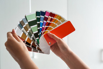 Sticker - Female interior designer with color palette samples indoors, closeup