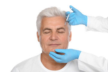 Senior man getting facial injection on white background. Cosmetic surgery concept