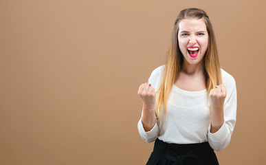 Wall Mural - Successful young woman on a brown background