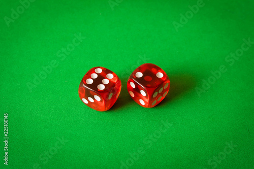 фотография Dice on a green background . Game concept. Games of chance