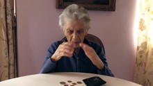 A Depressed Elderly Woman With No Money. Poverty Concept, Financial Problems. Filmed In 4K 