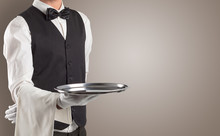 Waiter Serving With White Gloves And Steel Tray In An Empty Space
