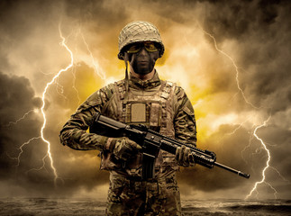 Armed soldier standing in rainy obscure weather
