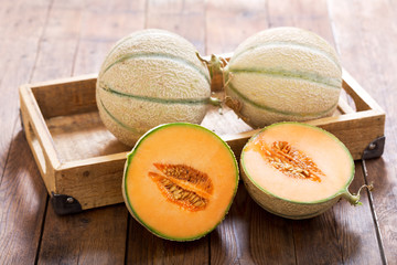 Wall Mural - cantaloupe melon on wooden table