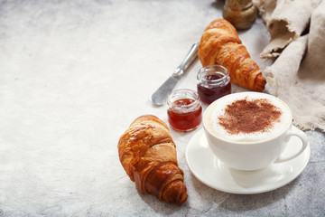 Wall Mural - Cup of cappuccino coffee with croissants