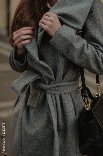 Fotografie, Tablou Woman holding her autumn coat closeup. Fashion style