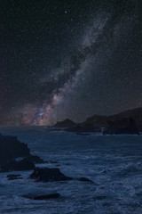 Canvas Print - Vibrant Milky Way composite image over landscape of long exposure sea over rocks