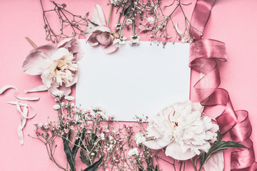 Wall Mural - Flowers and petal arrangement around blank paper on pink background with ribbons, top view. Love feeling letter.  Instagram style. Wedding invitation. Mother's Day. Greeting concept. Flat lay