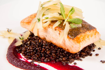 Sticker - Baked salmon, beetroot mousse, black lentils and pear on a white background