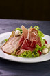 © alexmishchenko - Expensive Italian, Spanish, French salad for festive table. Snack from pear, mozzarella, jamon, greens, lettuce, sauce. Cuisine of France, Spain, Italy. Photo of food for menu, cookbook, culinary blog