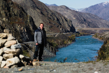 Poster - Man stands on the Katun river Bank in the Altai mountains, Russia.