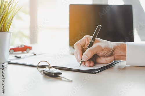 Cuadros en Lienzo close up shots hands of client signing car lease form.