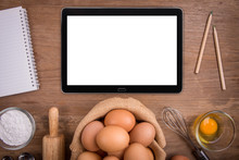 Tablet On Wood Background With Fresh Farm Eggs Whipping Eggs And Whisk,top View White Clipping Path Inside