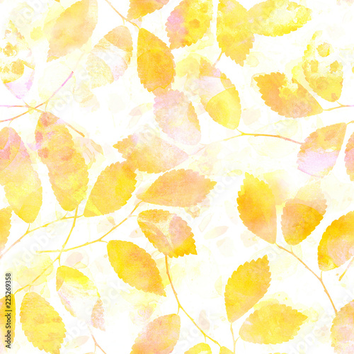A seamless pattern of yellow autumn leaves with watercolour splashes, a paste...