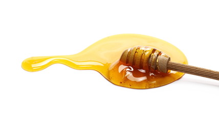 Honey and wooden dipper isolated on white background