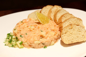 Fresh Tartar with Salmon and bread. Close