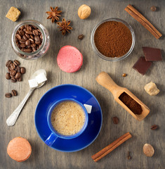 Poster - cup of coffee and beans on wooden background