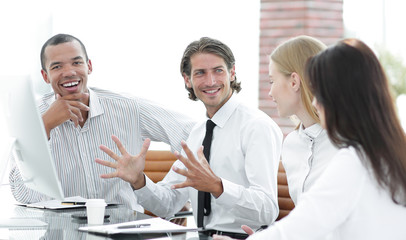 Wall Mural - businessman talking to a business team sitting at Desk.