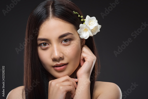 Portrait Of Beautiful Young Asian Woman With White Flowers In Hair