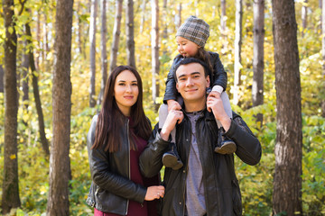 Parenthood, fall and people concept - young family happy in autumn park