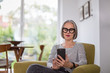 © ReeldealHD images - Mature adult female using a smartphone at home