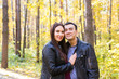 © satura_ - People, family and leisure concept - young couple having fun in the autumn park