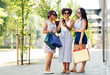 © Syda Productions - sale, consumerism and people concept - happy young women with smartphones and shopping bags on city street
