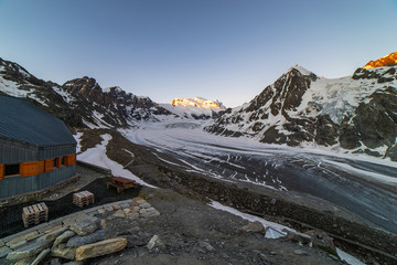 Wall Mural - Scenic view of beautiful landscape of Swiss Alps with a majestic Glacier de Corbassiere in a view, Switzerland. Clear sky sunrise in Valais Alps (Pennine Alps), Switzerland in a early morning light.