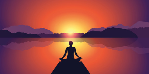 Wall Mural - meditation silhouette beautiful sunset at lake and mountain landscape background