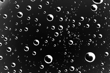 black wet background / raindrops for overlaying on window, concept of autumn weather, background of drops of water rain on glass transparent