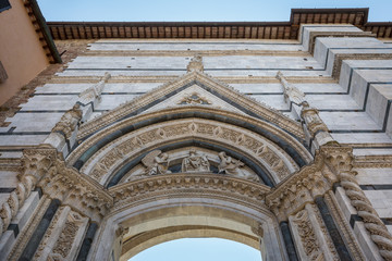 Wall Mural - Looking up at the gateway entrance to the piazza containing Siena cathedral