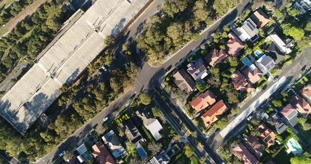 Poster - Lifting view from ground surface of house roof tops in local residential suburb Mosman on Sydney’s lower north shore towards horizon and city CBD landmarks across Harbour.
