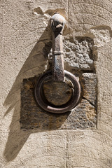 Wall Mural - Decorative iron rings and sculpture inset into the walls in Siena Tuscany, used for holding torches