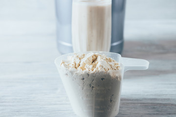 Wall Mural - Close-up scoop with serving of dry protein powder