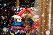 © Irina Schmidt - Funny happy child in fashion winter clothes making window shopping decorated with gifts, xmas tree