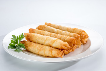 Cigar Pastries on a white plate.