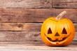 © DenisProduction.com - Funny Halloween pumpkin on wooden background. Traditional Halloween pumpkin and copy space. Halloween symbols and traditions.