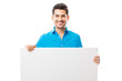 © AntonioDiaz - Attractive Male Smiling While Holding Blank Poster