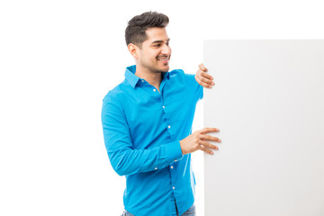 Wall Mural - Man Looking At Billboard Over White Background