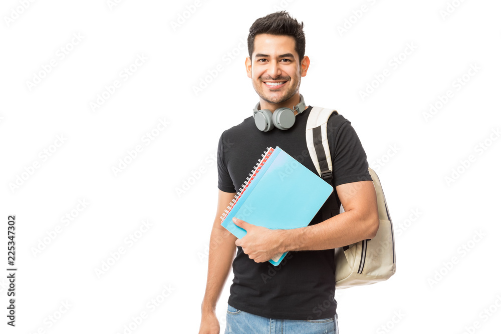Smiling Young College Student With Books And Backpack - obrazy, fototapety, plakaty 