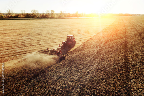 Fotografie, Obraz Agriculture machine harvesting crop in fields
