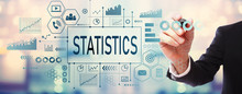 Statistics With Businessman On Blurred Abstract Background