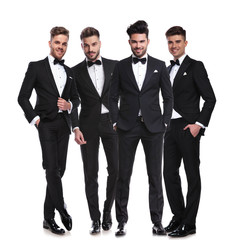 Canvas Print - four elegant young men in tuxedos standing together