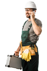 Canvas Print - handsome electrician talking by smartphone and holding toolbox isolated on white