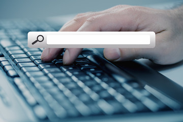 Man hand typing on keyboard with seach button.