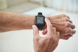 © DragonImages - Senior man checking pulse via health application in his smart watch
