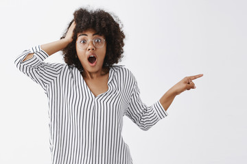 Wall Mural - did you just saw it. portrait of shocked and speechless confused african american woman in glasses a