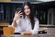 © tiniroma - Portrait of thai adult office girl using her smart phone Selfie