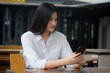 © tiniroma - Portrait of thai adult office girl using her smart phone