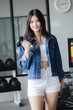 © tiniroma - Portrait of thai adult beautiful girl blue jeans in fitness relax and smile